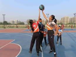 Students playing basketball together on an outdoor court