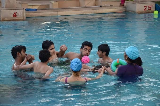 Children enjoying supervised water play in a pool